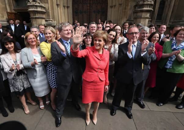 First Minister and leader of the SNP Nicola Sturgeon is joined by the newly elected SNP members of parliament outside the Houses of Parliament. Picture: Getty