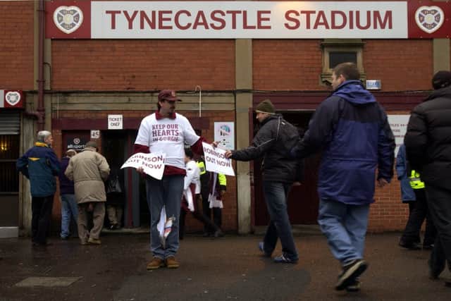 A fan campaigns to keep Hearts at their Tynecastle home. Picture: Phil Wilkinson