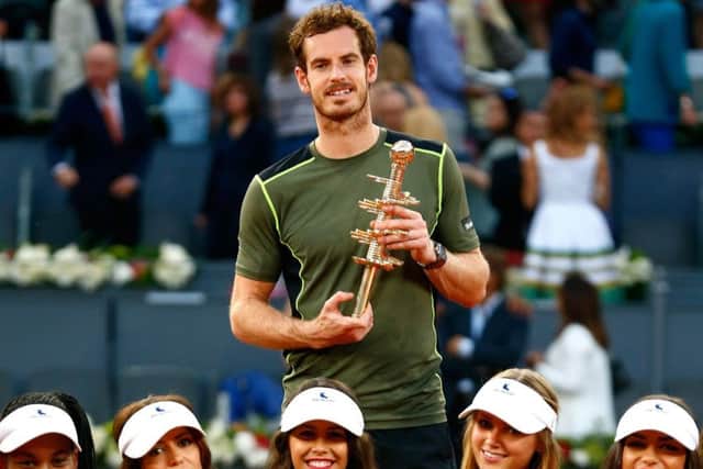 Andy Murray  surrounded by the events model ball girls  holds the Madrid trophy. Picture: Getty
