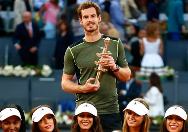 Andy Murray  surrounded by the events model ball girls  holds the Madrid trophy. Picture: Getty