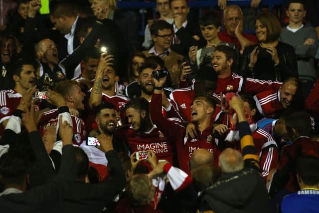 Swindon Town players are mobbed by jubilant fans after last nights incredible 55 draw with Sheffield United. Picture: Getty