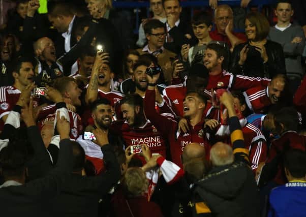 Swindon Town players are mobbed by jubilant fans after last nights incredible 55 draw with Sheffield United. Picture: Getty