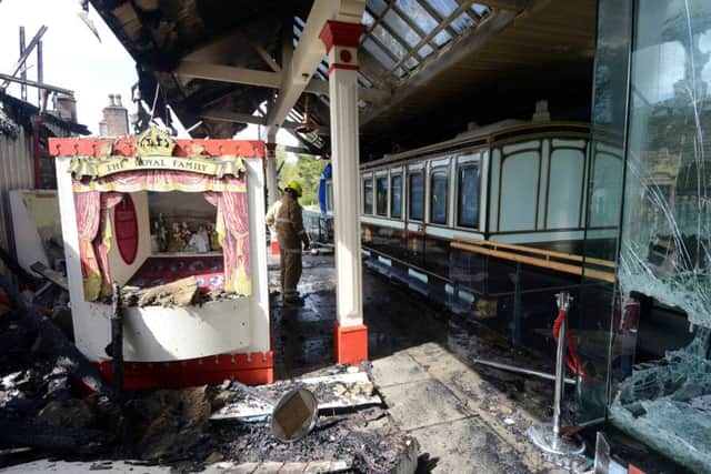 A fireman inspects the Royal Carriage at the historic Old Railway Station, in Ballater, Aberdeenshire this morning, where a fire has destroyed the Station after a blaze ripped through the building starting in the early hours of this morning. Pic: HEMEDIA