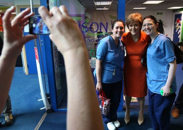First Minister Nicola Sturgeon poses for a photo with a group of nurses during a visit to Edinburgh Royal Infirmary. Picture: PA