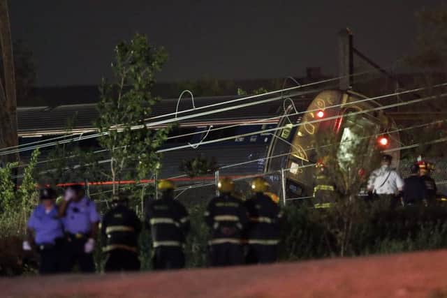 Emergency personnel work at the scene of the crash. Picture: AP