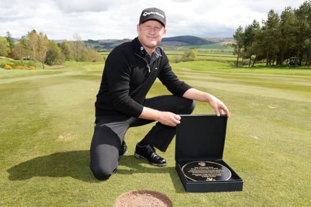 Jamie Donaldson with the plaque marking the spot from where he hit the winning shot in last year's Ryder Cup at Gleneagles. Picture: SNS