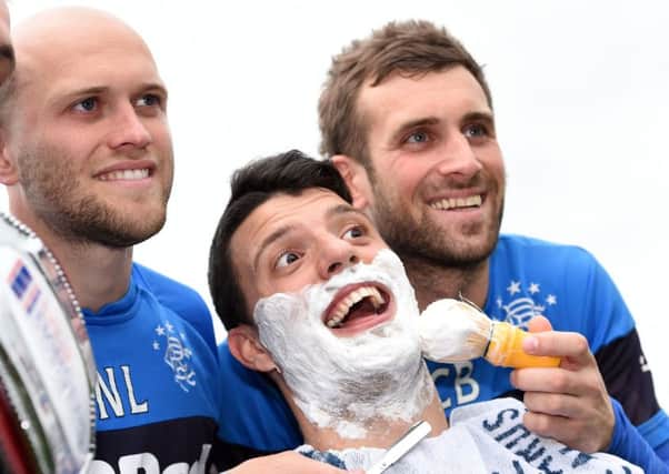 A close shave for Haris Vuckic as Rangers teammates Nicky Law and Cammy Bell practise their skills. Picture: SNS