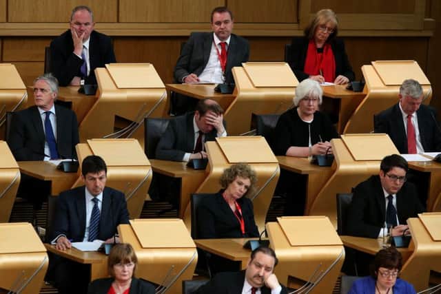 Scottish Labour MSPs, including Richard Baker, centre, listen to a statement by Scotland's First Minister Nicola Sturgeon. Picture: PA