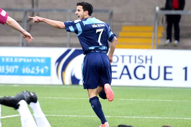 Omar Kader wheels away to celebrate after opening the scoring. Picture: SNS