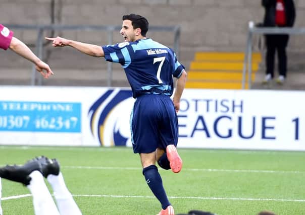Omar Kader wheels away to celebrate after opening the scoring. Picture: SNS