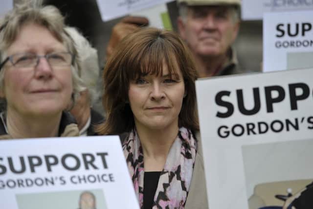 Supporters of 66-year-old disabled grandfather Gordon Ross  gathered today in Parliament Square, Edinburgh. Picture: Ian Rutherford. Mr Ross'  daughter Veronica is pictured. Picture: Ian Rutherford