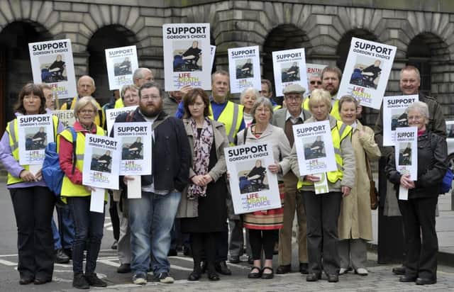 Supporters of 66-year-old disabled grandfather Gordon Ross gathered today in Parliament Square, Edinburgh. Picture: Ian Rutherford