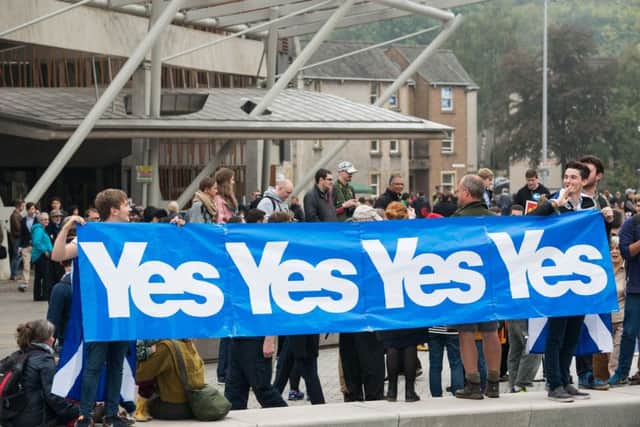 Pro-independence supporters campaign outside the Scottish Parliament in September 2014. Picture: Ian Georgeson