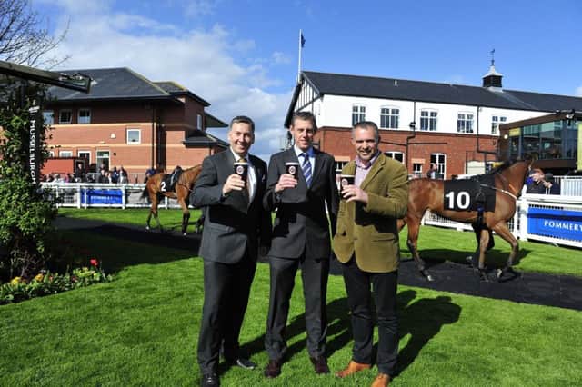 Musselburgh Racecourse general manager Bill Farnsworth, centre, toasts the sponsorship deal. Picture: Joey Kelly
