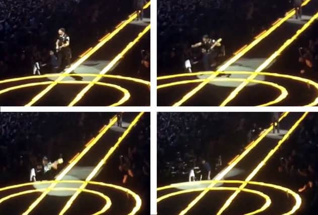 Going...going...going...gone: The Edge takes a tumble off the stage. Pictures: YouTube