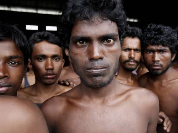 Newly arrived migrants gather at Kuala Langsa Port in Langsa yesterday. Picture: AP