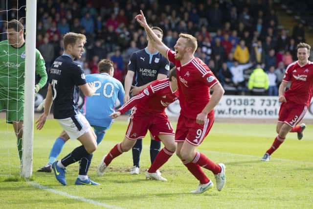Adam Rooney celebrates after grabbing a last-gasp equaliser for Aberdeen. Picture: SNS