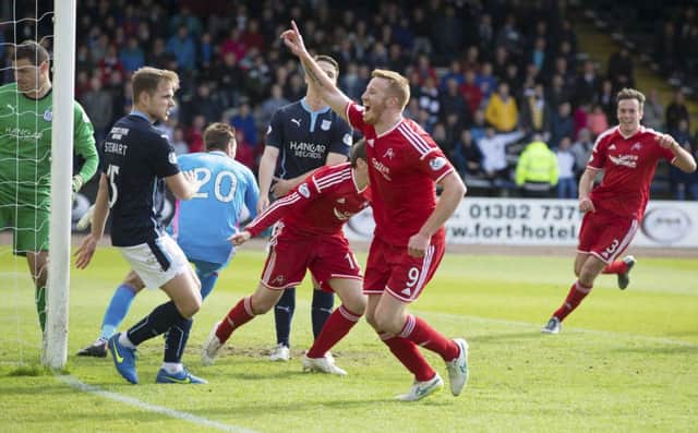 Adam Rooney celebrates after grabbing a last-gasp equaliser for Aberdeen. Picture: SNS