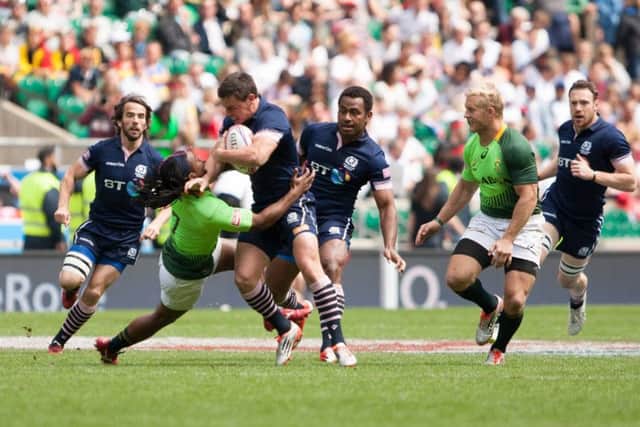 Scotlands Lee Jones is tackled by South Africas Branco du Preez in the Plate semi-final. Picture: SportPix