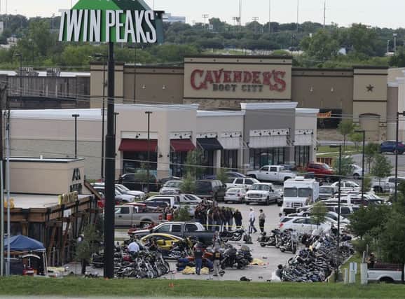 Authorities investigate a shooting in the parking lot of the Twin Peaks restaurant. Picture: AP