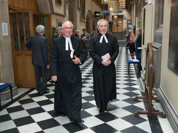 The Moderator of the General Assembly of the Church of Scotland, the Rt Rev Dr Angus Morrison, left, leaves the morning session. Picture: Andrew OBrien