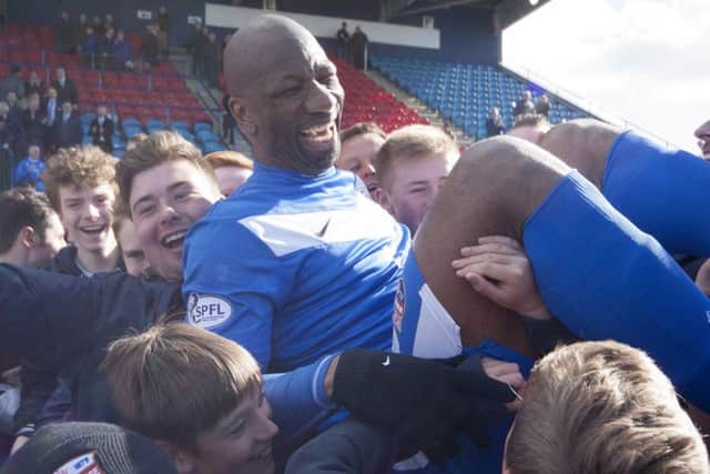 Goalscoring hero Marvin Andrews is carried off the field by jubilant Montrose fans. Picture: Paul Reid