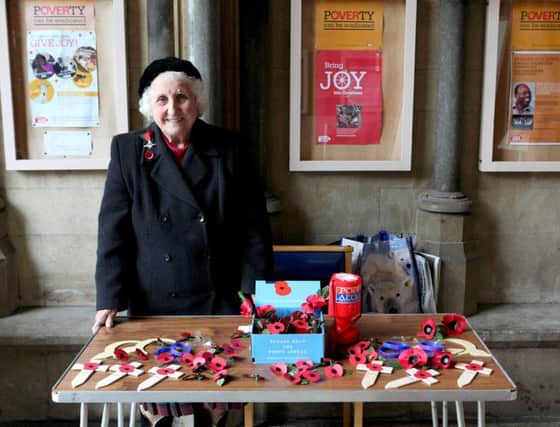 Poppy seller Olive Cooke outside Bristol Cathedral. Picture: SWNS