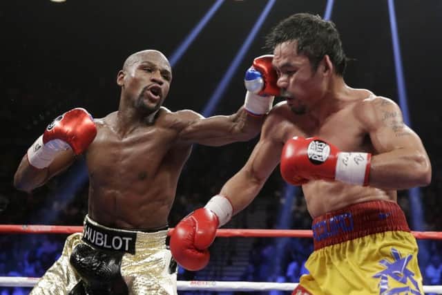 Floyd Mayweather Jr, left, hits Manny Pacquiao, during their welterweight title fight in Las Vegas earlier this month. Picture: AP