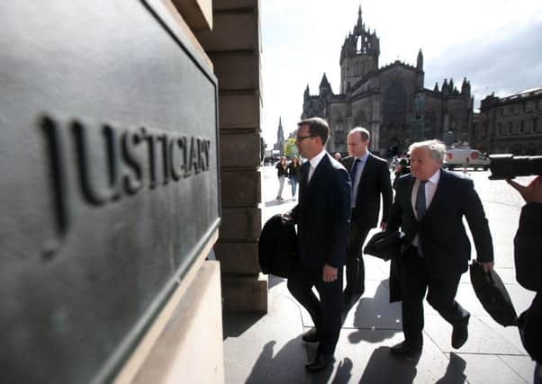 Former News of the World editor Andy Coulson (left) arrives  with his legal team at the High Court in Edinburgh as his perjury trial continues. Picture: PA