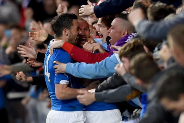 Rangers fans celebrate with goalscorer Kenny Miller, centre, and Nicky Clark, left after he doubles his side's lead. Picture: SNS