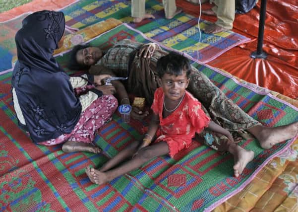 A Rohingya woman receives medical treatment after her family arrived in Aceh, Indonesia. Picture: AP