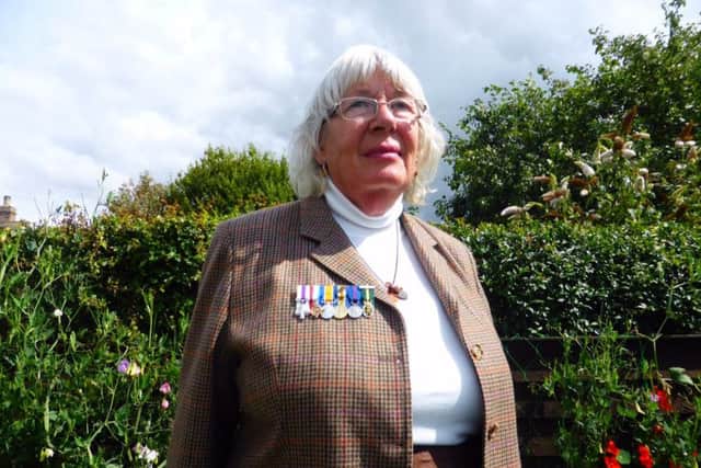 Artist Susan Hughes, above, wears miniatures of the medals awarded to her grandfather Major Alexander Wightman. Picture: Contributed