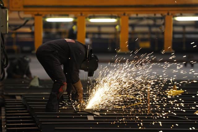 A grinder at work on an aircraft carrier in Govan. Picture: Robert Perry
