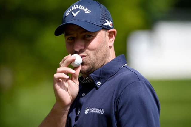 Craig Lee kisses the ball that he holed for his ace at Wentworth. Picture: Getty