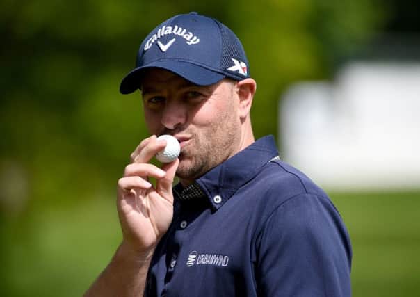 Craig Lee kisses the ball that he holed for his ace at Wentworth. Picture: Getty