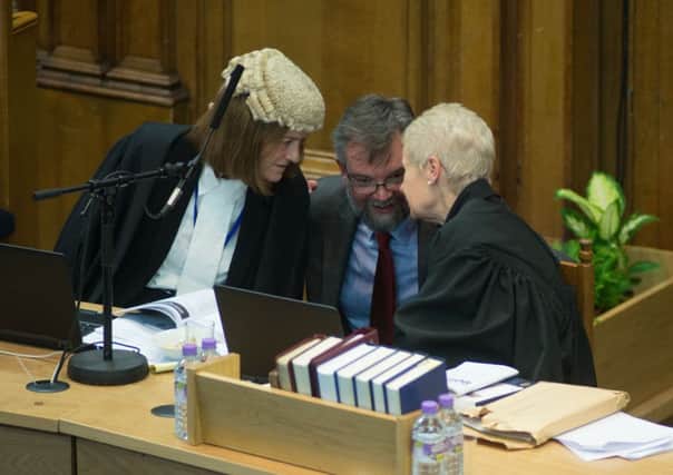 The Rev Alan Hamilton in discussion with Procurator Laura Dunlop QC, left, and Solicitor Janette Wilson during the debate. Picture: Andrew OBrien