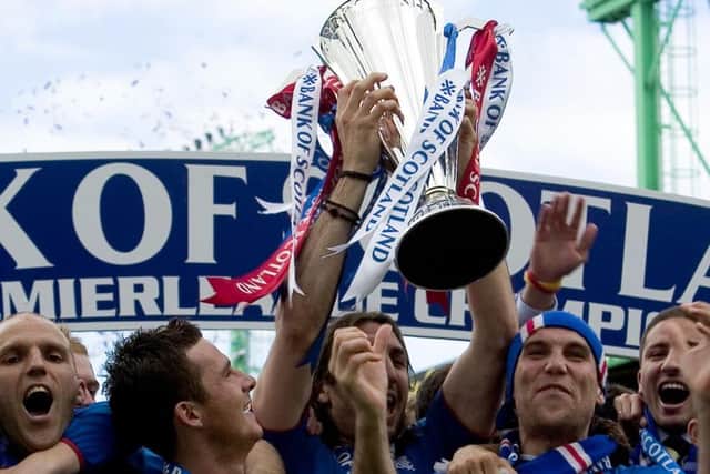 Alex Rae, Barry Ferguson and Dado Prso celebrate after being handed the title. Picture: SNS