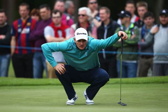 Justin Rose lines up a putt, after completing his round of 72, the Englishman criticised the condition of the greens. Picture: Getty