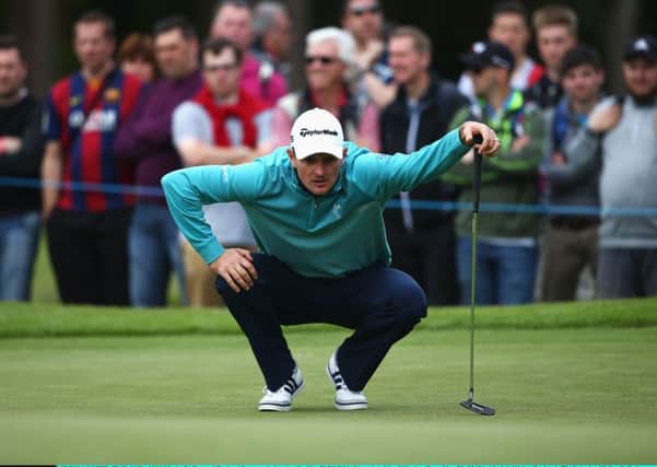 Justin Rose lines up a putt, after completing his round of 72, the Englishman criticised the condition of the greens.  Picture: Getty