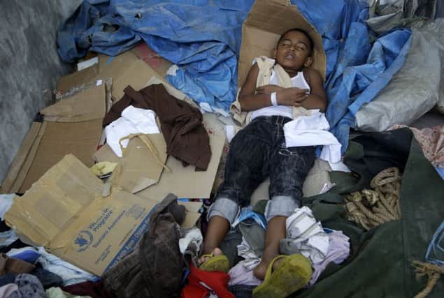 A Rohingya migrant child sleeps at a temporary shelter in Kuala Langsa, Aceh province, Indonesia, yesterday. Picture: AP