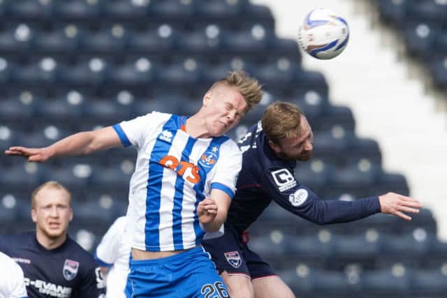 Kilmarnock's Mark O'Hara (left) and Ross County's Craig Curran battle for the header. Picture: SNS