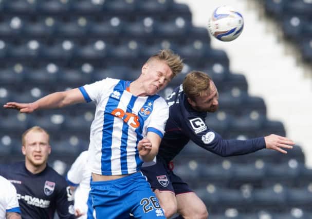 Kilmarnock's Mark O'Hara (left) and Ross County's Craig Curran battle for the header. Picture: SNS