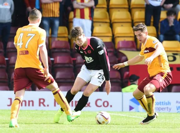 Partick's Jack Hendry (centre) runs from Motherwell's Conor Grant (left) and Stuart Carswell. Picture: SNS