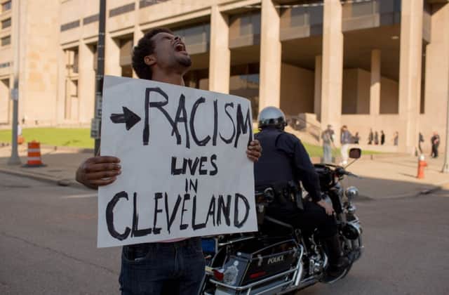 Clevelander Tanis Quach protests outside the Justice Building. Picture: Getty