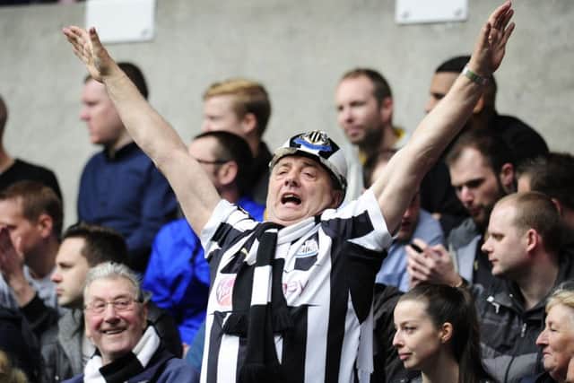 A Newcastle fan celebrates as the Magpies ensure Premier League football. Picture: PA