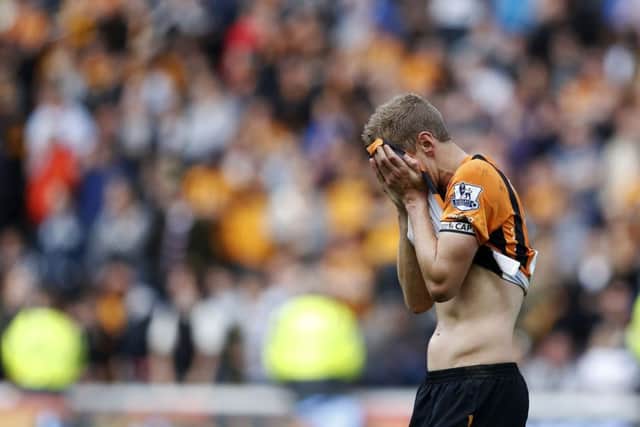 Michael Dawson reacts after Hull's fate is sealed. Picture: PA