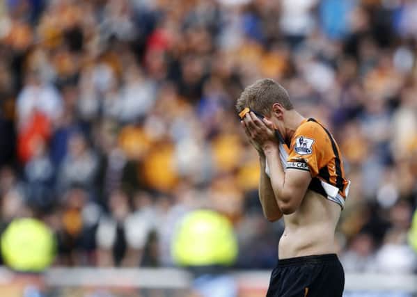 Michael Dawson reacts after Hull's fate is sealed. Picture: PA