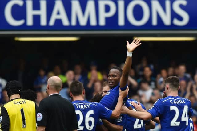 Didier Drogba is bizarrely carried off by his team-mates. Picture: Getty