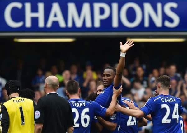 Didier Drogba is bizarrely carried off by his team-mates. Picture: Getty