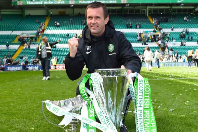 Ronny Deila celebrates with the Premiership trophy at Celtic Park. Picture: SNS
